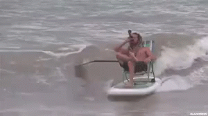 a man is riding on a paddle boat in the ocean