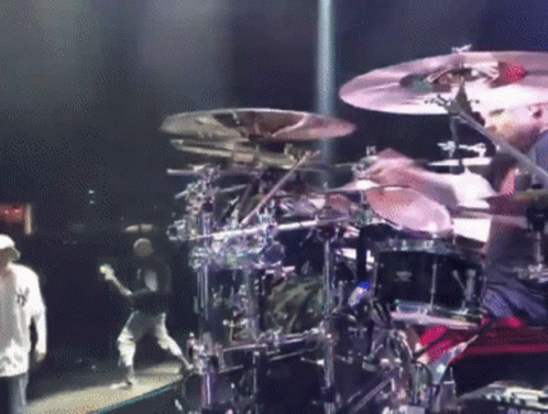 a person is playing drums on stage