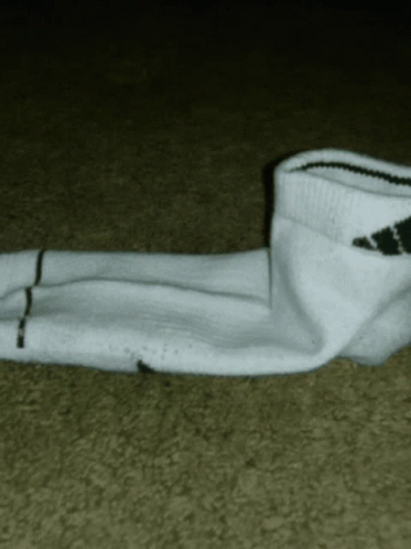 someone wearing socks is lying down on the floor