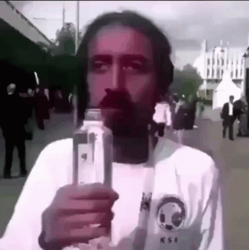 a man is taking a selfie on a cellphone