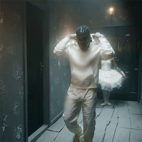 man in white jacket walking into a restroom