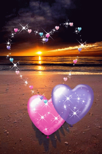 hearts floating in the air at night on a beach