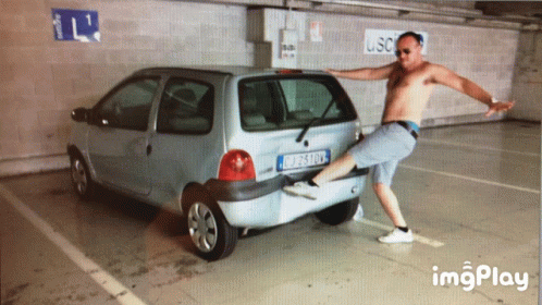 a man is leaning on a small car
