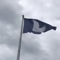 a flag flies on the pole at an airport