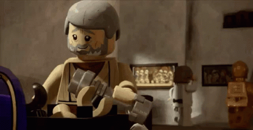 a lego character holding an electronic device and wearing helmet