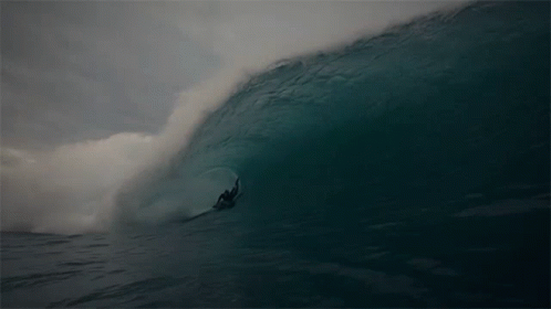 a surfer is catching a huge wave in the water