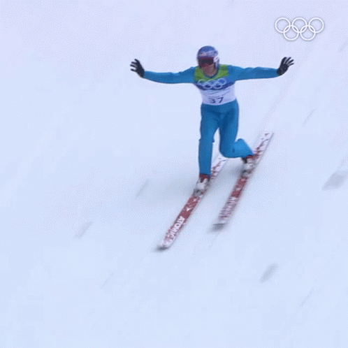 a man skiing down a snowy mountain in the olympics