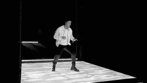 a man is walking on stage in an exhibit