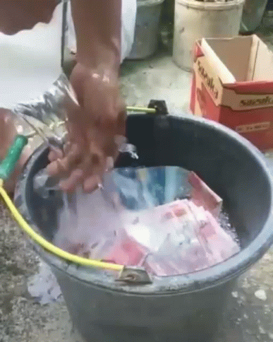 a person is putting purple stuff into a bucket