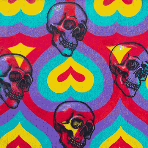 some painted skulls on a wall and colorful patterns