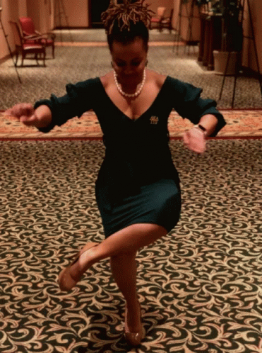 a woman in a brown dress doing an unusual dance