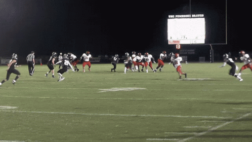 some football players running across a field