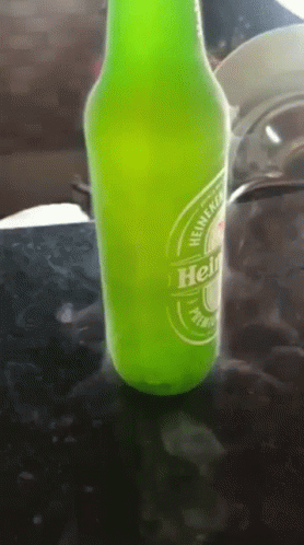 a bottle with a lid sitting on the table next to a bottle