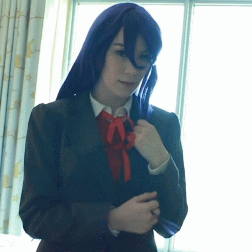 a girl in a suit with a bright purple bow tie