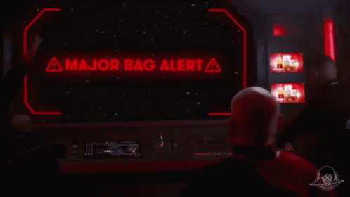 a person standing in front of a television set with the word major bag alert