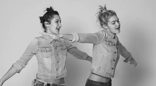 two girls dancing together in tight denims and shirts