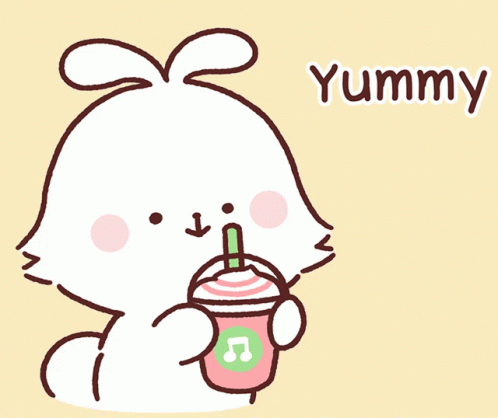 a little white rabbit holding a cup of juice