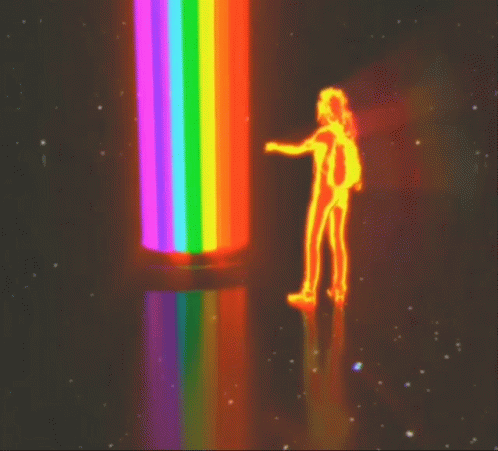 the person is next to a rainbow colored object