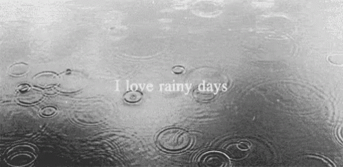 rain is falling down on a window with i love rainy days