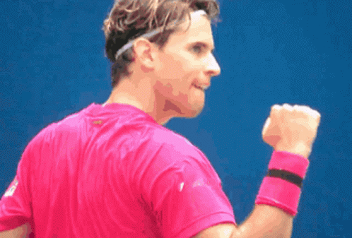 a tennis player celetes a win and fist bump