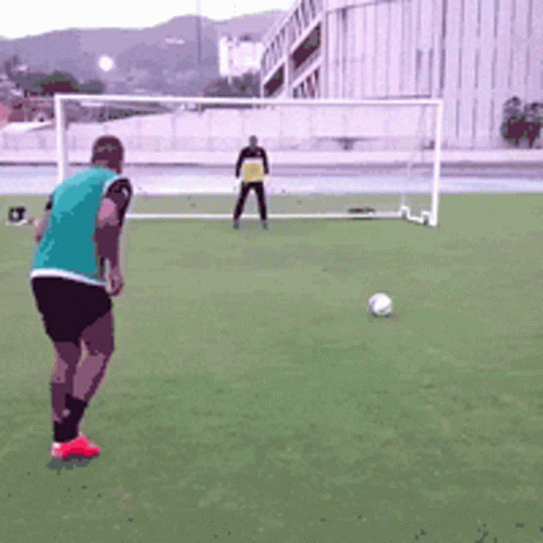 a man in a field is getting ready to kick a soccer ball