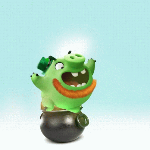a very cute small green toy that is sitting on a ball