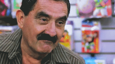 a man with a mustache standing in a store