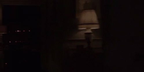 a person walks out of a dark corridor at night