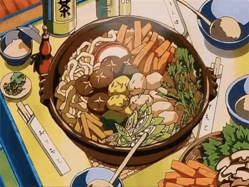 a large bowl of food sits on top of a table
