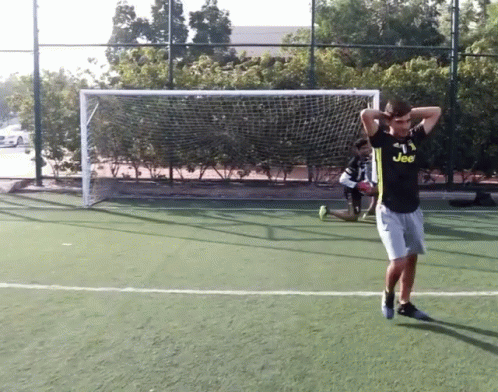 the man is practicing hitting a ball at a soccer game