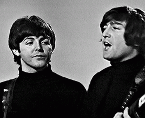 two young men with guitars are wearing turtle neck sweaters