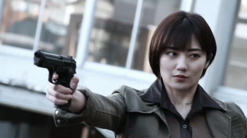 a woman holding a gun on the street