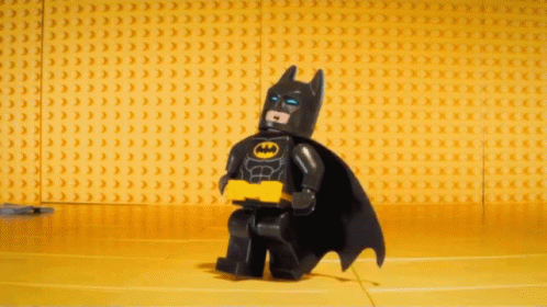 a lego bat is sitting in a blue room