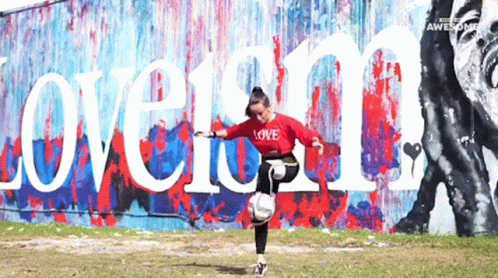 a man running next to graffiti covered wall