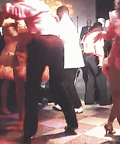 a man and a women dancing with a crowd