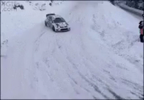 a car is seen traveling through the snow
