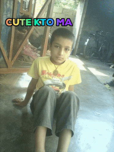 a boy is sitting on the floor with his feet spread