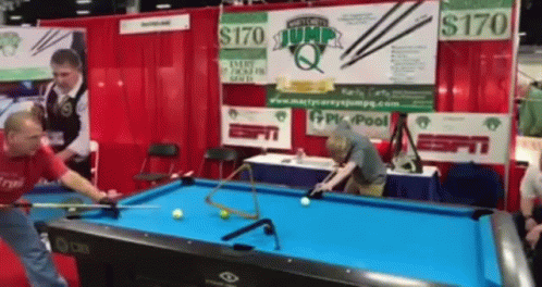 two men are playing pool on a table
