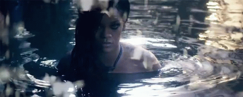 a woman is submerged in water with her head hanging out