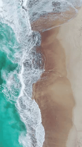 an aerial view of the surf and beach at beach