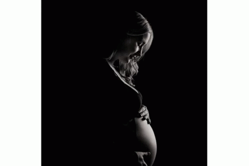 a pregnant woman with a cigarette in her hand
