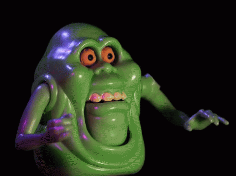 a green neon - lit character is making a face