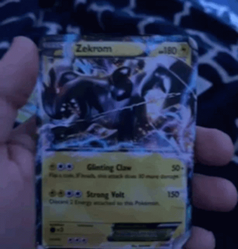person holding up a card game character from the pokemon tcm