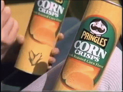 a person holding two bottles of corn drink