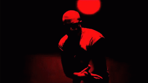 a man is standing in a dark room