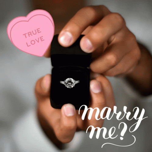 a person holding a phone with a ring and two hearts