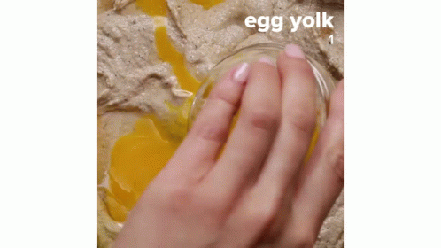 a hand holding a glass with the caption, egg yolk