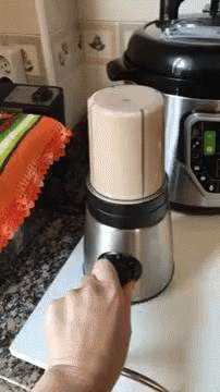someone using a manual to turn the electric juicer