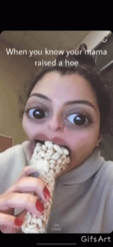 a woman covered in googly eyes eating a popcorn