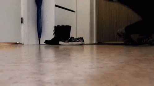 a person in boots is walking into a room